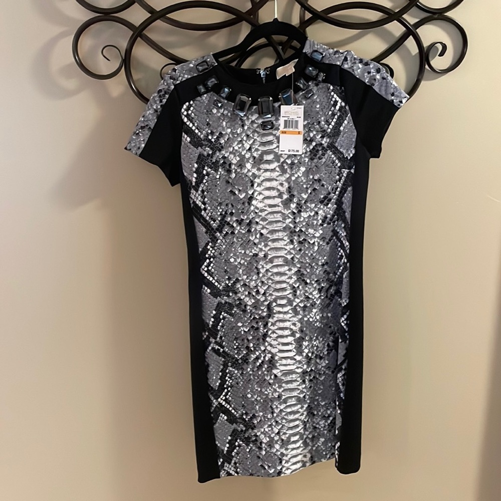 Pretty dress- never worn. Great details and jewel neckline